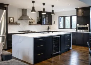 Modern kitchen with dark cabinets and white countertop.